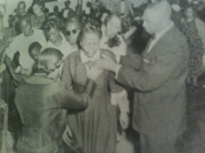 evangelist mattie b. poole and bishop charles e. poole praying for the sick