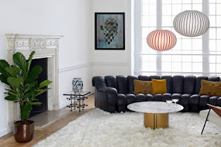 white living room with black sofa