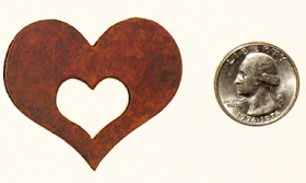 heart-shaped magnet, next to a quarter, for sizing