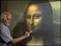 NRC scientist Marc Rioux examines the virtual 3-D model of the painting using a multi-resolution display system also developed at NRC.