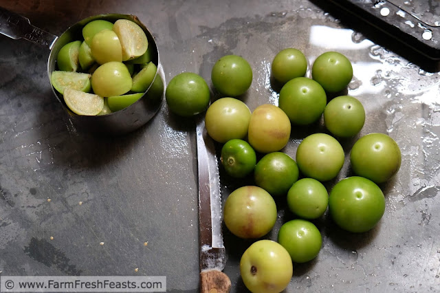 tomatillos being chopped for salsa verde with roasted hatch chiles