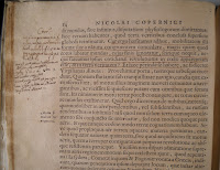 A page of printed text with handwritten notes in the margins.