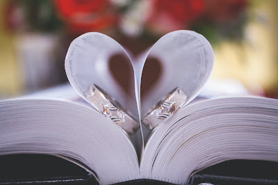 Book lying open with pages forming a heart shape