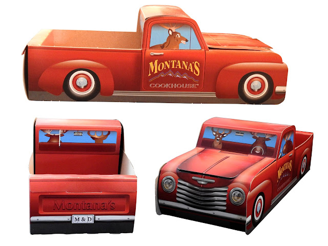 A red half-ton truck made of cardboard from Montana's Cookhouse.