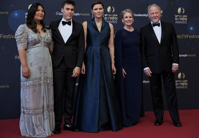 Princess Charlene wore a sleeveless navy gown by Akris. Federica Tosi gown. Diamond necklace and earrings
