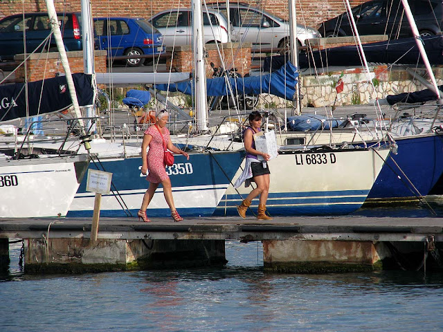 Ladies on a jetty at the marina, Porto Mediceo, Livorno