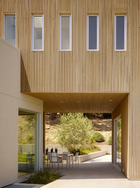 Terrace of Home with Wooden Wall and Wide Glass Windows near it