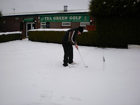 Minigolfer Richard Gottfried attempting to play on the snowed under Crazy Golf course at Tea Green Golf, Wandon End, Luton