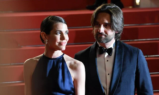 Charlotte Casiraghi wore a night blue v-neck and v-back silk satin evening gown by Chanel. Chanel diamond earrings