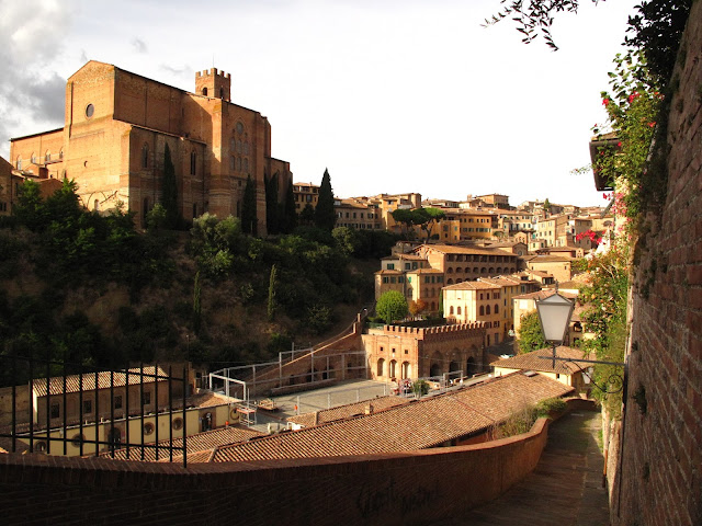 Sunset over San Domenico Church and Fonte Branda below, Siena, Tuscany, Italy