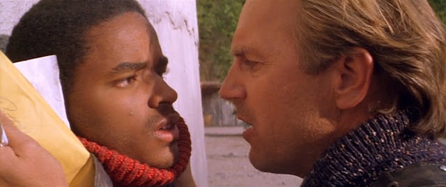 The Postman and Ford (Larenz Tate) differ about the value of the mail.