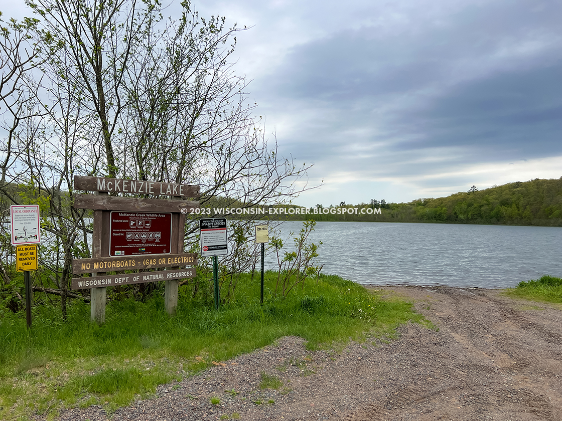 signage next to a boat ramp