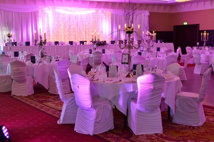  the ballroom dressed in our chloe chair covers with purple uplighting 
