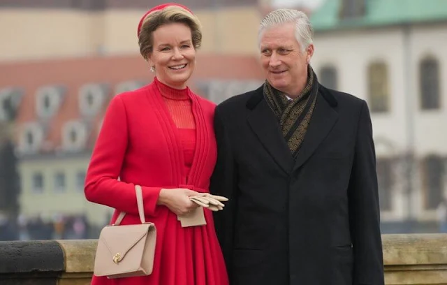 Queen Mathilde wore a red dress outfit, and fur collar coat in camel. Federal President Frank-Walter Steinmeier and Elke Büdenbender