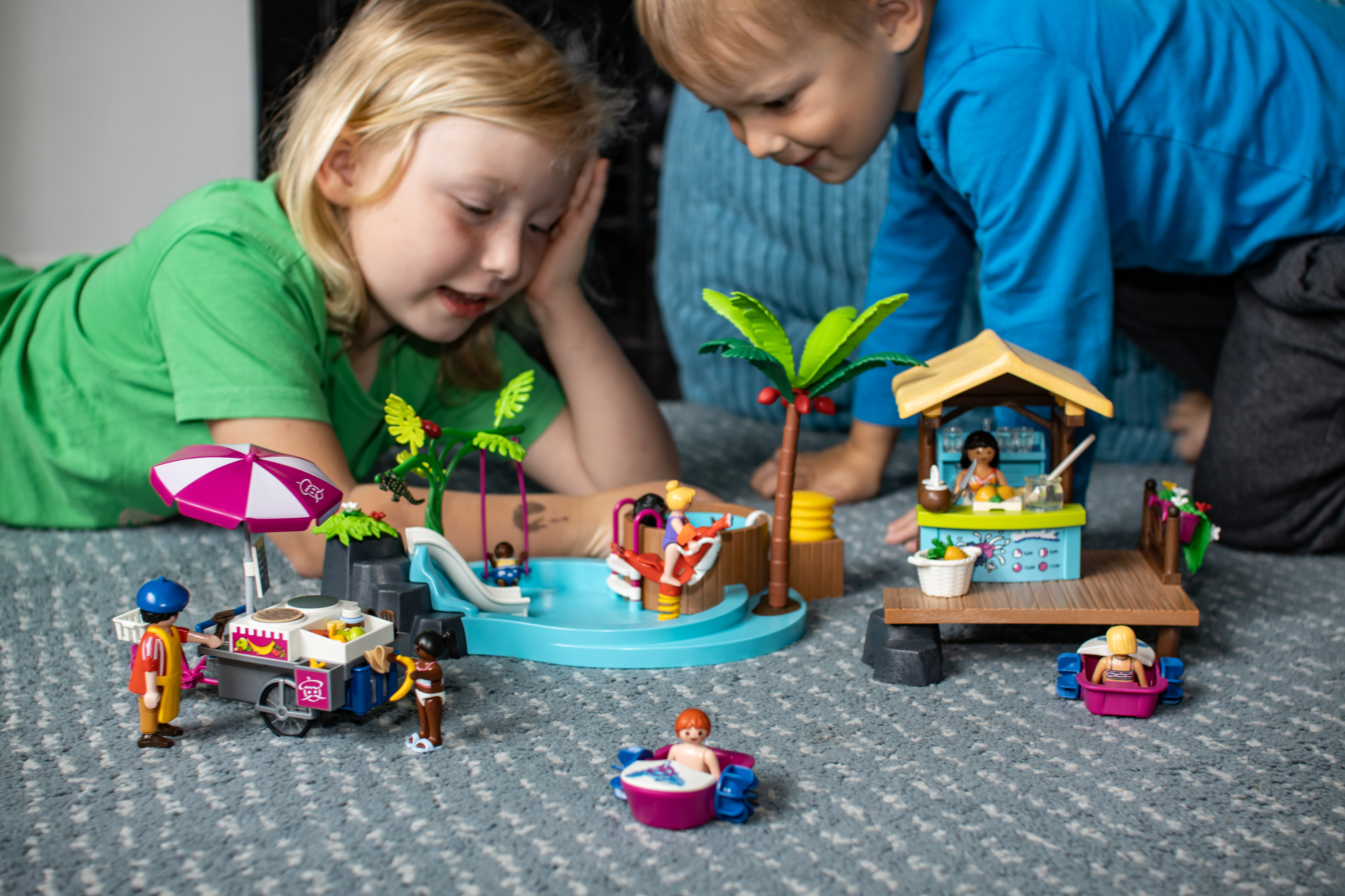 children looking at assembled Playmobil Family Fun beach holiday sets