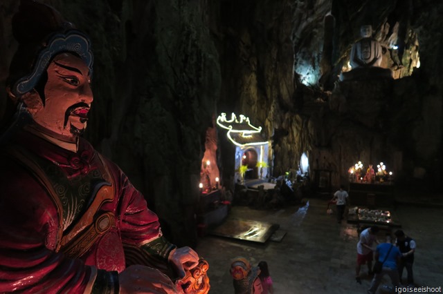 Huyen Khong Cave with fierce looking deities, sitting on cute looking tigers.