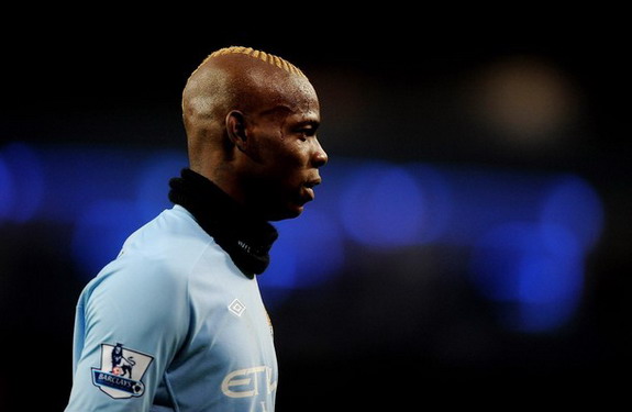 Manchester City forward Mario Balotelli wears a snood around his neck during a match