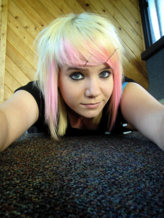18 years of age, asymmetrical cut, currently black and pink hair. The 