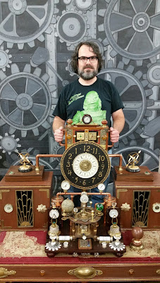 Man steering a 19th Century-style time machine.