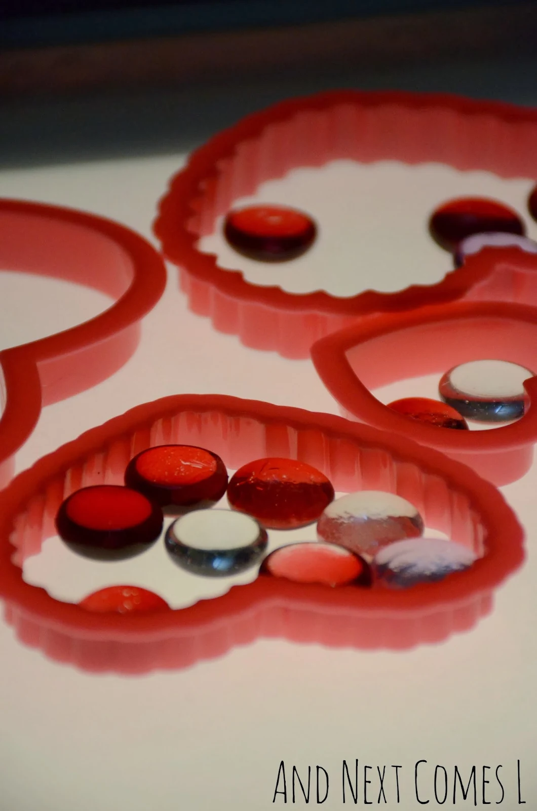 Close up of hearts and glass stones on the light table - perfect for Valentine's Day from And Next Comes L