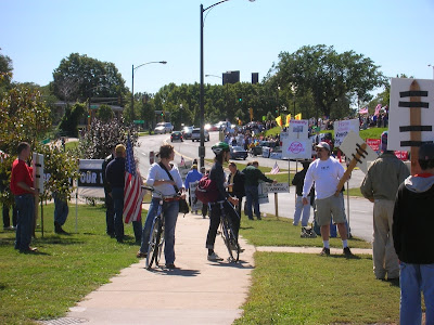 A pair of anti-war bicyclists challenge the conservative counterprotest at Saturday's WAMM march