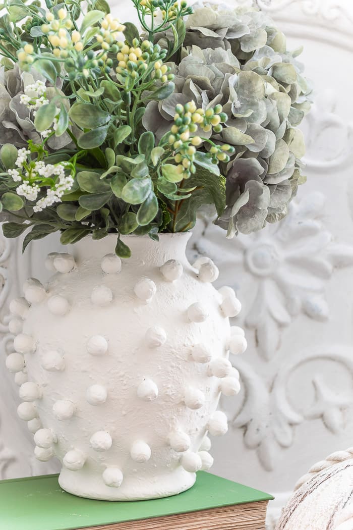 white textured vase with greenery