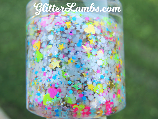 Glitter Lambs "Summer Smoothie" Glitter Nail Polish is a custom handmade glitter topper nail polish made for doing some awesome summer nails! Summer Smoothie nail polish has gold holographic hearts, gold holographic stars, neon green hearts, neon hot pink hearts, mini pink stars, mini blue stars, mini yellow stars, and more! Glitter Lambs Nail Polish www.GlitterLambs.com Glitter Nails Glitter Nail Polishes for Sale