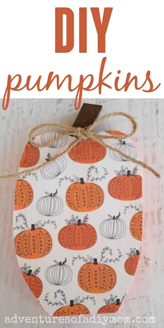 painted wooden pumpkin decoupaged with scrapbook paper