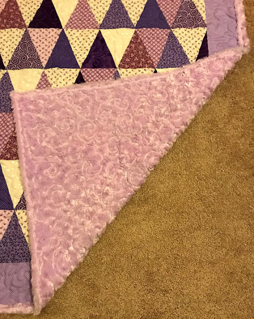 Soft and pretty purple quilt.