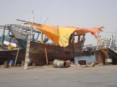 The bright orange of this dhow's cover contrast with the colours around it.