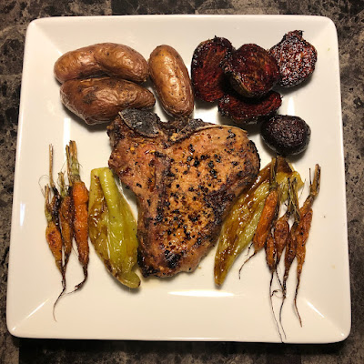 grilled veal loin chop along with some oven roasted root vegetables