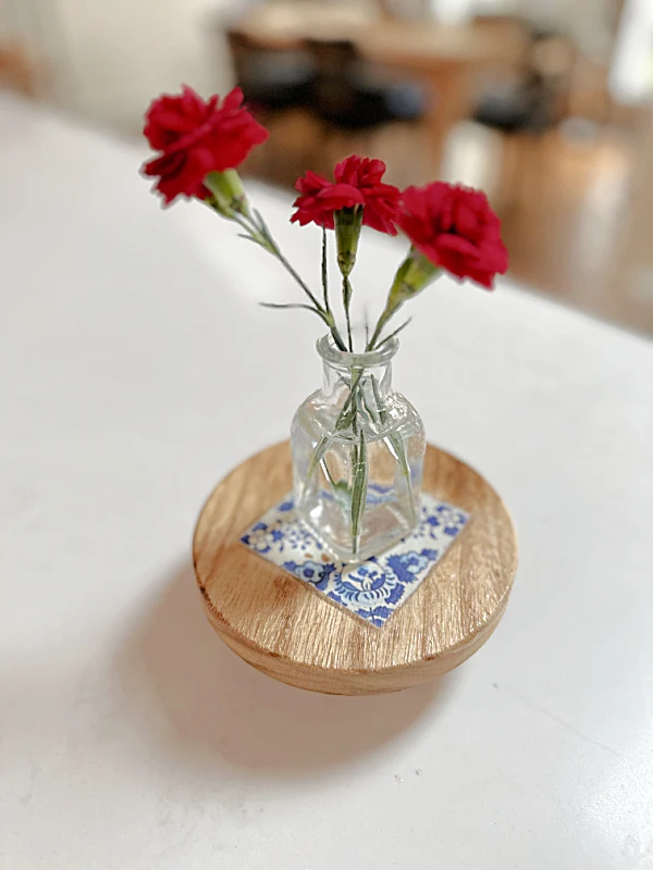 flowers in a vase on a riser with transfer