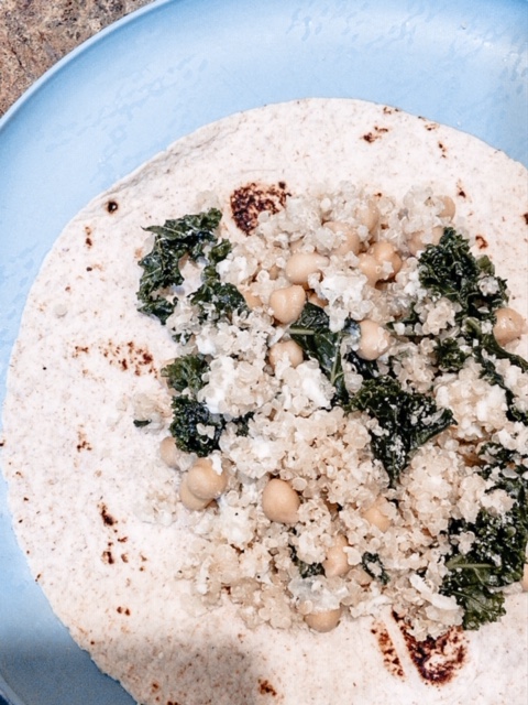 egg white, kale, chickpeas, and quinoa breakfast burrito on a blue plate