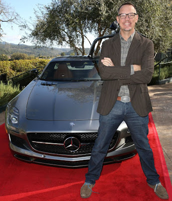 Heather Helm's husband sitting in front of his car