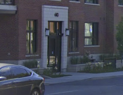 Google Street View image of a front entranceway close to a sidewalk with a driveway that dips the sidewalk down, partially obscured by a car (443 Kent Street)