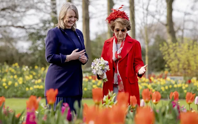 Dutch Princess Margriet is wearing a red wool coat by Max Mara, and red earrings. Garden of Europe or Keukenhof park