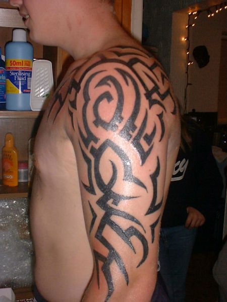 maori arm tattoos. Puzzled tribal arm tattoo for guys.