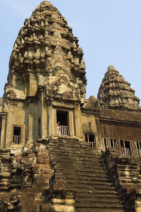Almost vertical and narrow stone steps leads to the upper gallery of Angkor Wat.