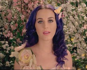 Katy Perry, natural, girly look with pale pink lipglossed lips, a slick of mascara and delicately lined eyes.