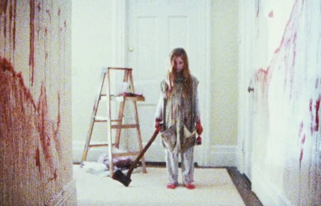 Young Clare Foley weilding an axe in a bloody hallway