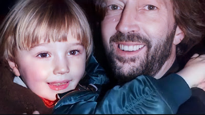 Eric Clapton holding 4-year-old son Conor