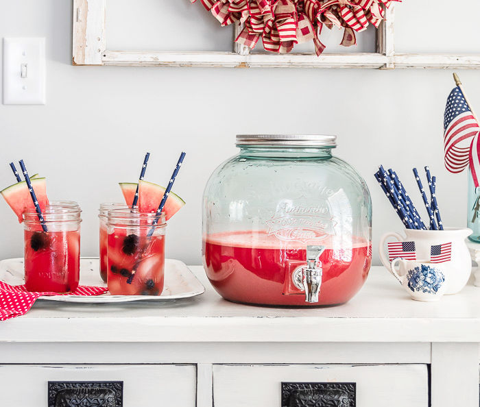 summer drink station, vintage drink dispenser, white table, mason jars with watermelon agua fresca