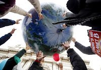 Protesters throw up a globe-shaped balloon during a rally held the day before the start of the 2015 Paris World Climate Change Conference, known as the COP21 summit, in Rome, Italy, November 29 2015. (Credit: Reuters/Alessandro Bianchi/File Photo) Click to Enlarge.