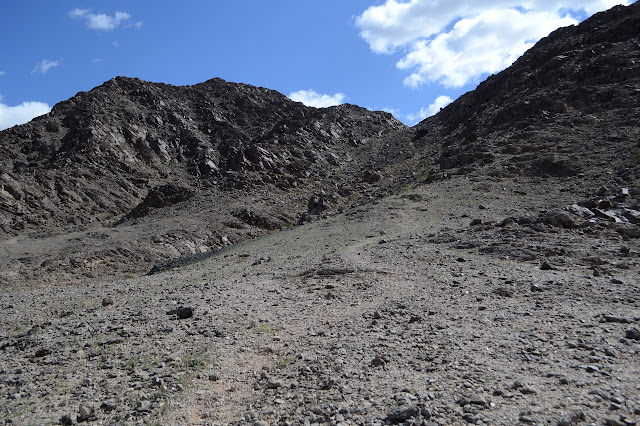 faint trail winding up the west side of a wash