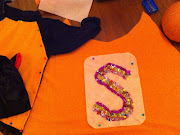I sewed orange to a black cat costume and then made her a cape with a sequin .