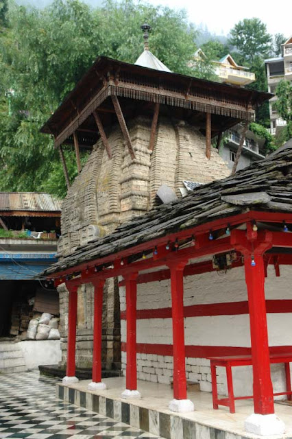 Vashishth Temple in the town of Manu-Dev (Manali), Himachal Pradesh : Posted by VJ SHARMA at www.travellingcamera.com : Vashishth Temple is near Manali which is famous for hot water springs and sand-stone temples on river bank of BEAS... Here are few few photographs of  the place with some more details....Here is main temple @ Vashishth.. There are two separate hot-water springs on the right side... These two pools of hot water are covered and meant for men/women separately.. People take bath before darshans inside the temple...Here is another temple near the main one ....Temple is situated at the suburbs of Manali which have Hot-Water Springs having special significance for their medicinal value...The gushing waters of the hot brooks are excellent ailments for skin diseases.... Large number of people come here to have a dip in these hot streams.... The authorities have arranged separate bathing provisions for men and women....Wooden Entry Gate for Vashishth Temple with amazing carving.... These stone temples show excellent and exquisite carvings on woods....There are some very good eating outs around this temple... We spent some time at a restaurant on first floor having complete view to the market and streets there... During this, we observed that many foreigners come there for many months to learn Yoga, Meditation etc... There are lot many Yoga and Mediation centers around the Temple...There is another small temple in market @ Vashishth, Manali, Himachal Pradesh....