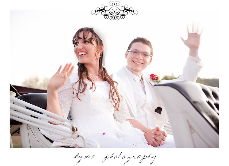 Rosemary and Jared riding away in a horse drawn carriage at their wedding in Santa Rosa California