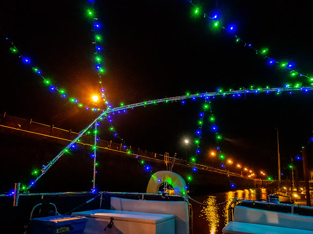 Photo of lights across Ravensdale's bimini frame and across her aft deck