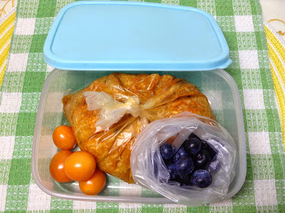 Packet of mixed vegetables and rice with blue berries and cherry tomato for lunch