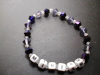 small purple and lavender crystal bracelet that says "miriam"